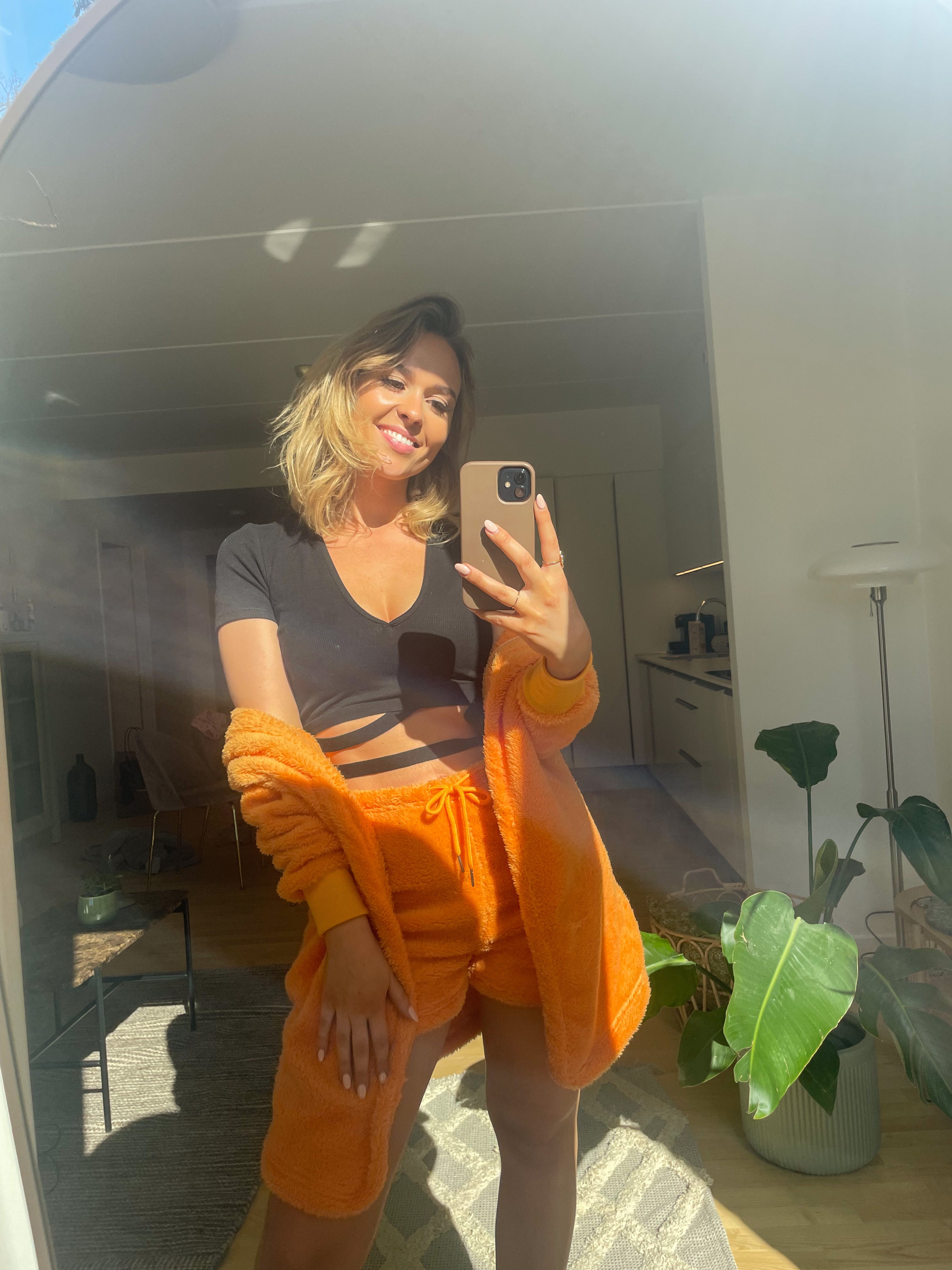 En dame iført orange hyggetøj.