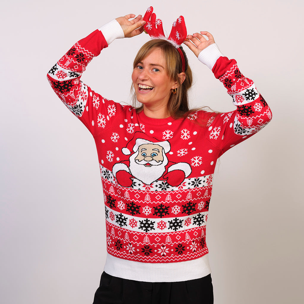 En kvinde poserer i hendes røde julesweater.