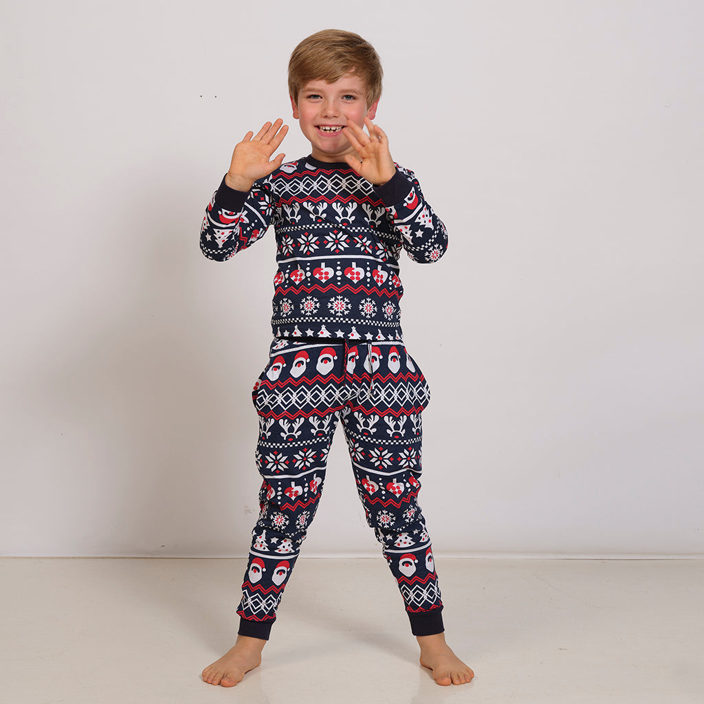 Et barn iført et sæt blå julepyjamas.