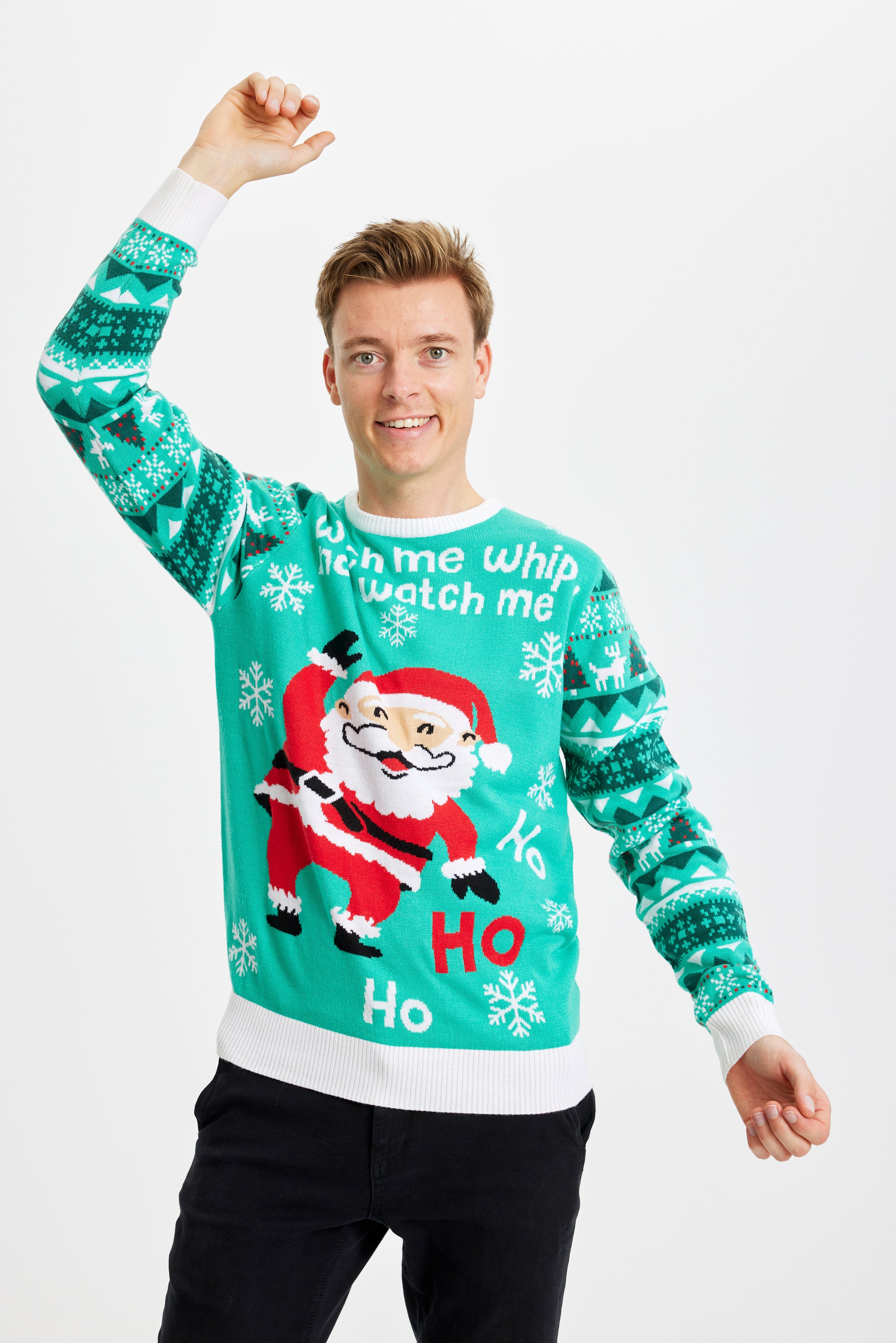 En smilende mand iført en turkis julesweater.