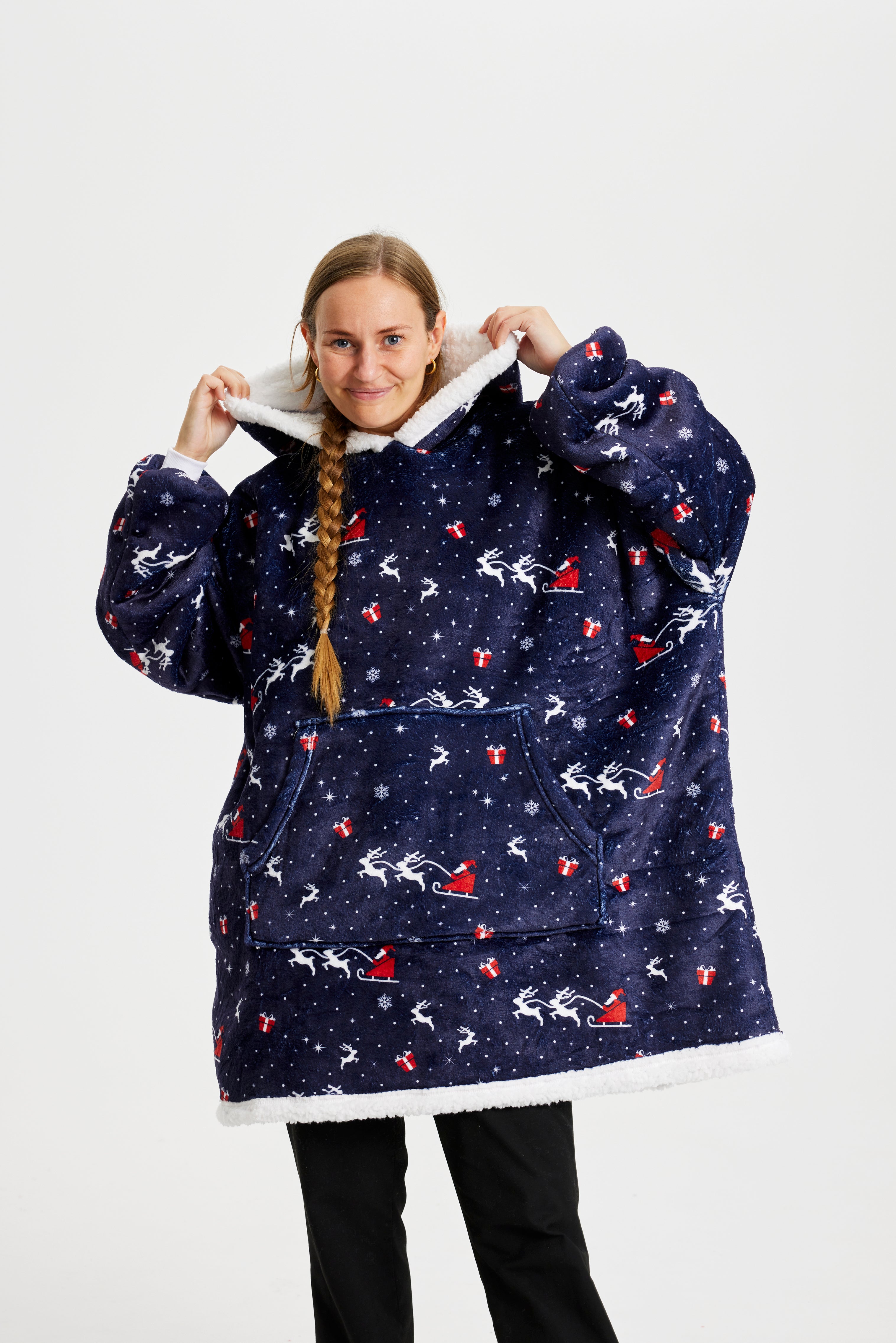 En kvinde med en fletning iført en mørkeblå julehoodie.