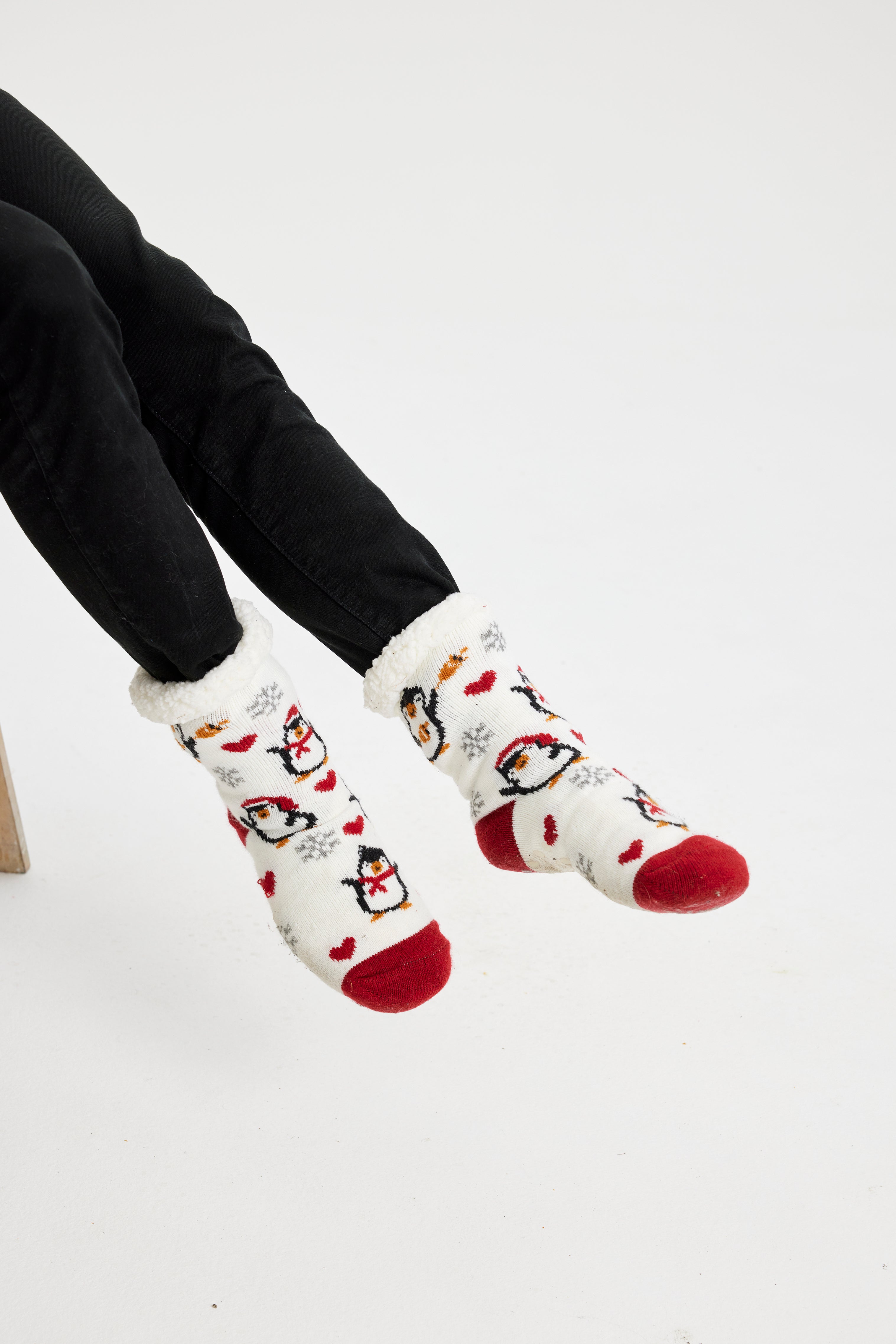 Et par fødder med hvide julesokker med rød spids og rød hæl.